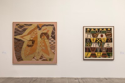 Two wall-hung weavings, one of which features a female figure set against a star.