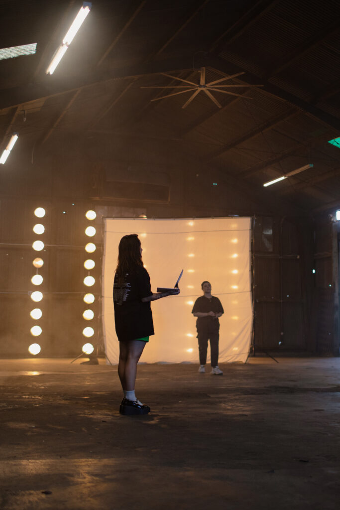 A choreographer on set with a laptop.