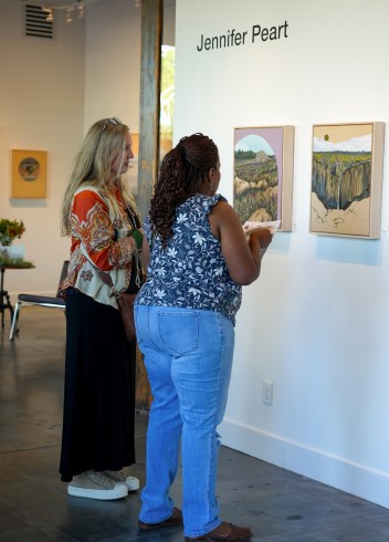 During a May 9 opening reception at janeGallery, visitors discuss art by painter Jennifer Peart’s art. (Photo by Marie-Elena Schembri)