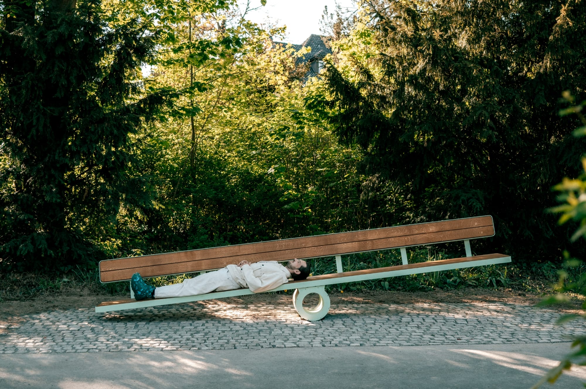 a white man lays on a bench that tilts toward his weight