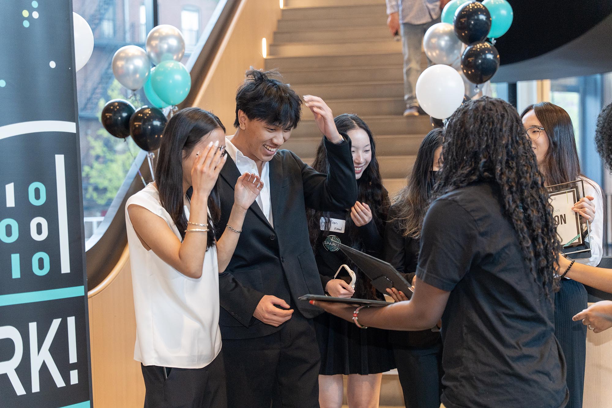 Photo: A group of students in formal attire prep for a photo.