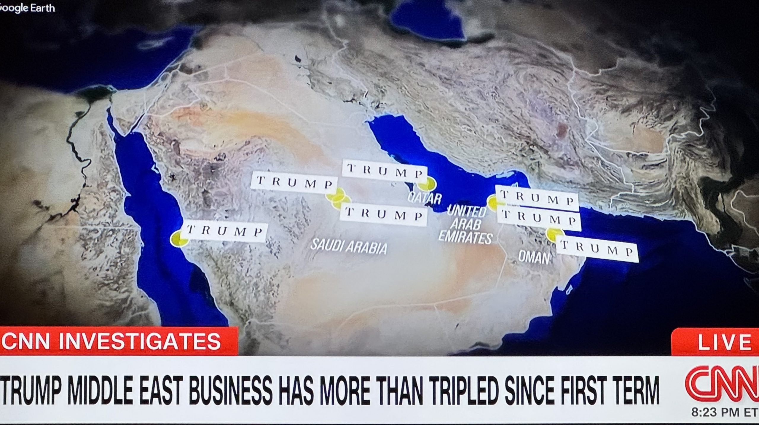CNN broadcast screenshot featuring a map of the Middle East with the headline: “TRUMP MIDDLE EAST BUSINESS HAS MORE THAN TRIPLED SINCE FIRST TERM.” The map shows labeled locations across countries including Saudi Arabia, Qatar, United Arab Emirates, and Oman, all marked with the name “TRUMP” in capital letters and yellow dots, suggesting business ventures or affiliations. The graphic is based on a satellite-style image from Google Earth. A “CNN INVESTIGATES” banner appears at the bottom left, and the timestamp reads 8:23 PM ET.
