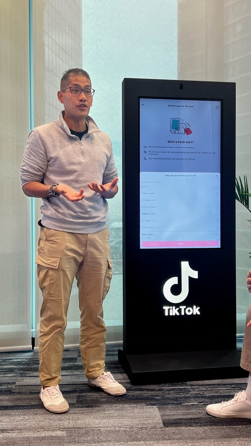 A TikTok official is explaining the TikTok function at the