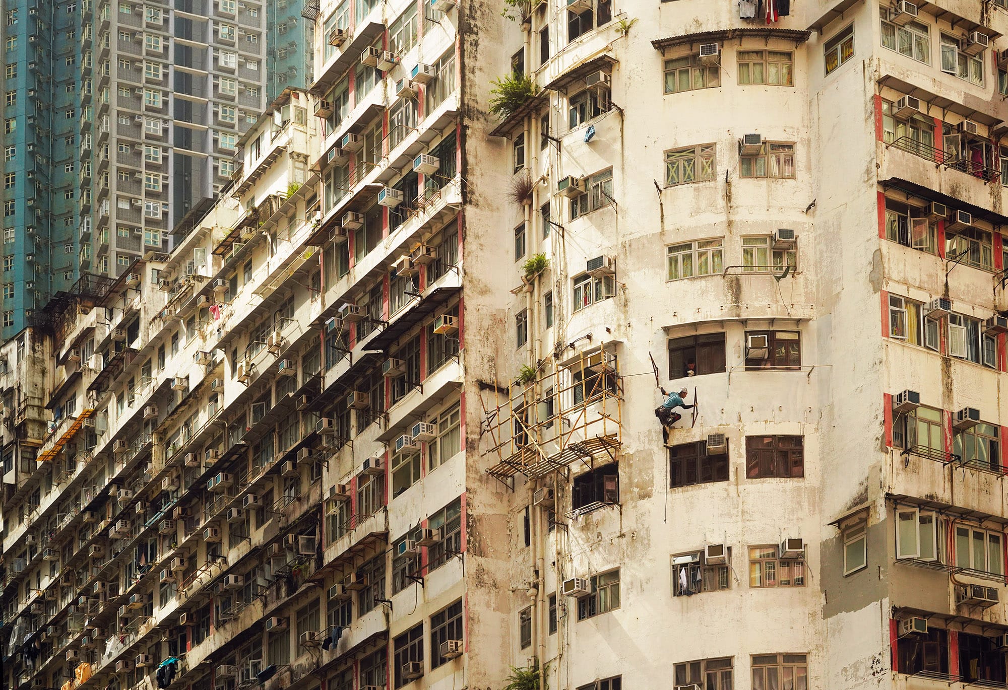 a detail image of a person hanging from the side of a building