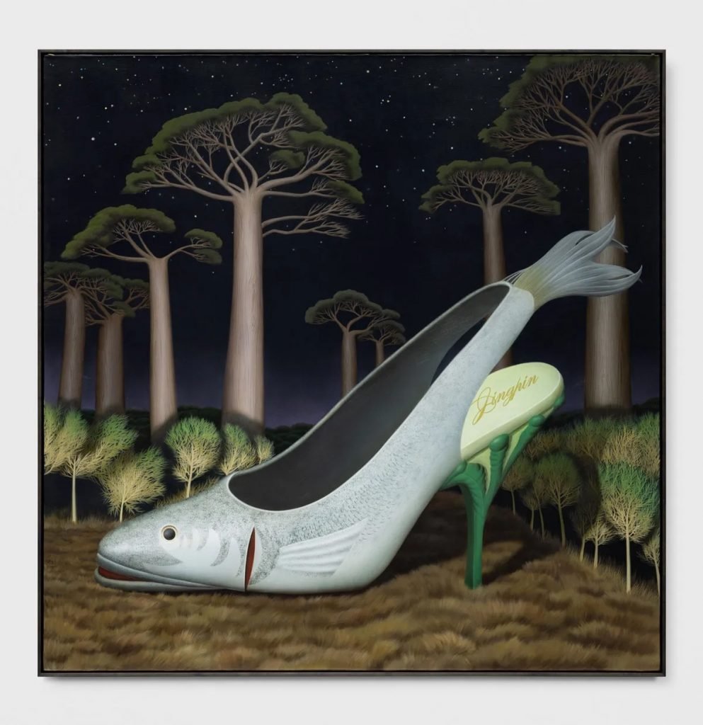a giant high heel in the shape of fish in the woods with tree around it