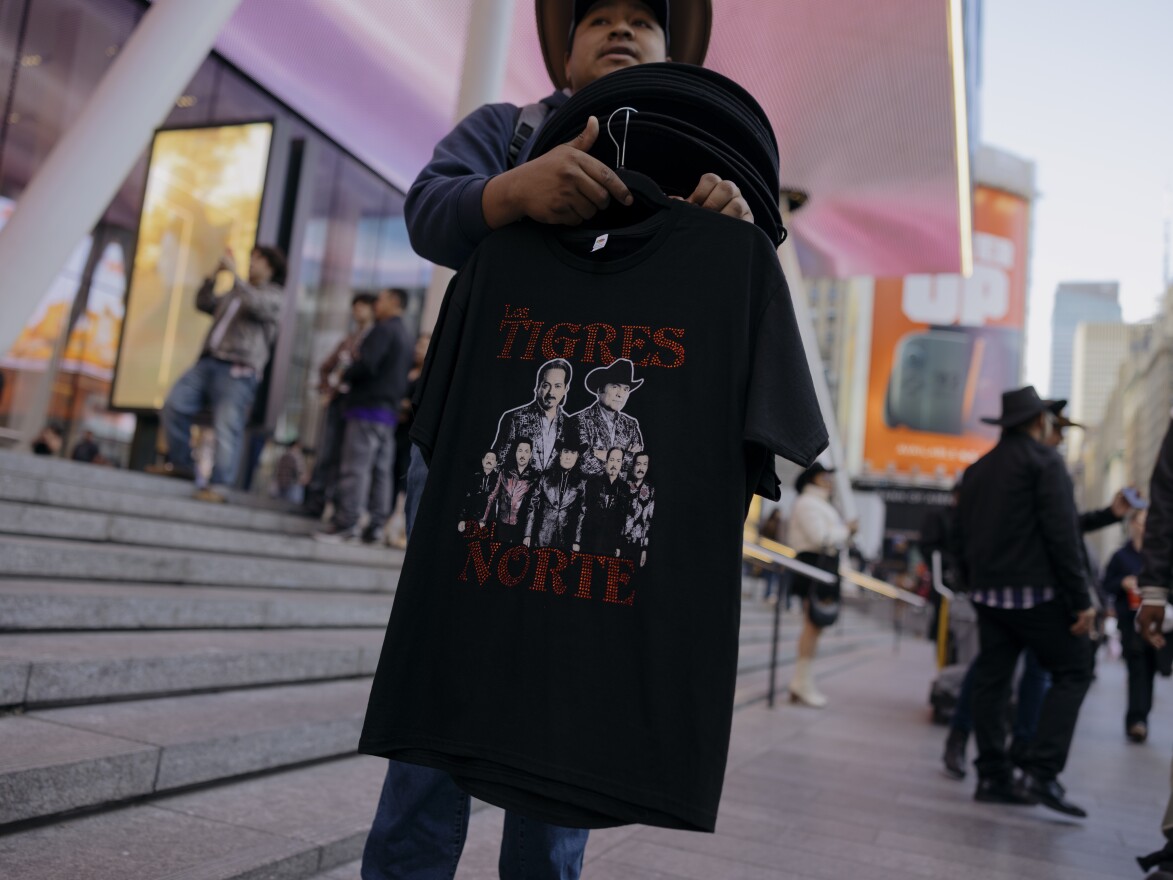 As hundreds of fans of the norteño band Los Tigres del Norte navigate the bustling block outside of Madison Square Garden, vendors sell shirts, hats, and drinks before the start of the Sinaloa, Mexico band's show at Madison Square Garden.