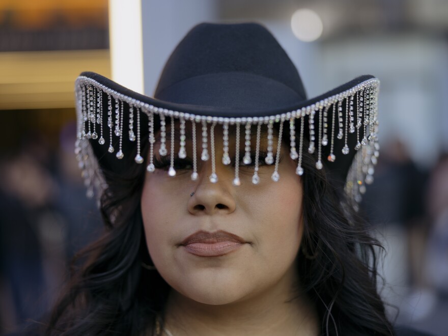 Vanessa Huesca stands for a portrait in her hat before the start of the norteño band Los Tigres del Norte show at Madison Square Garden.