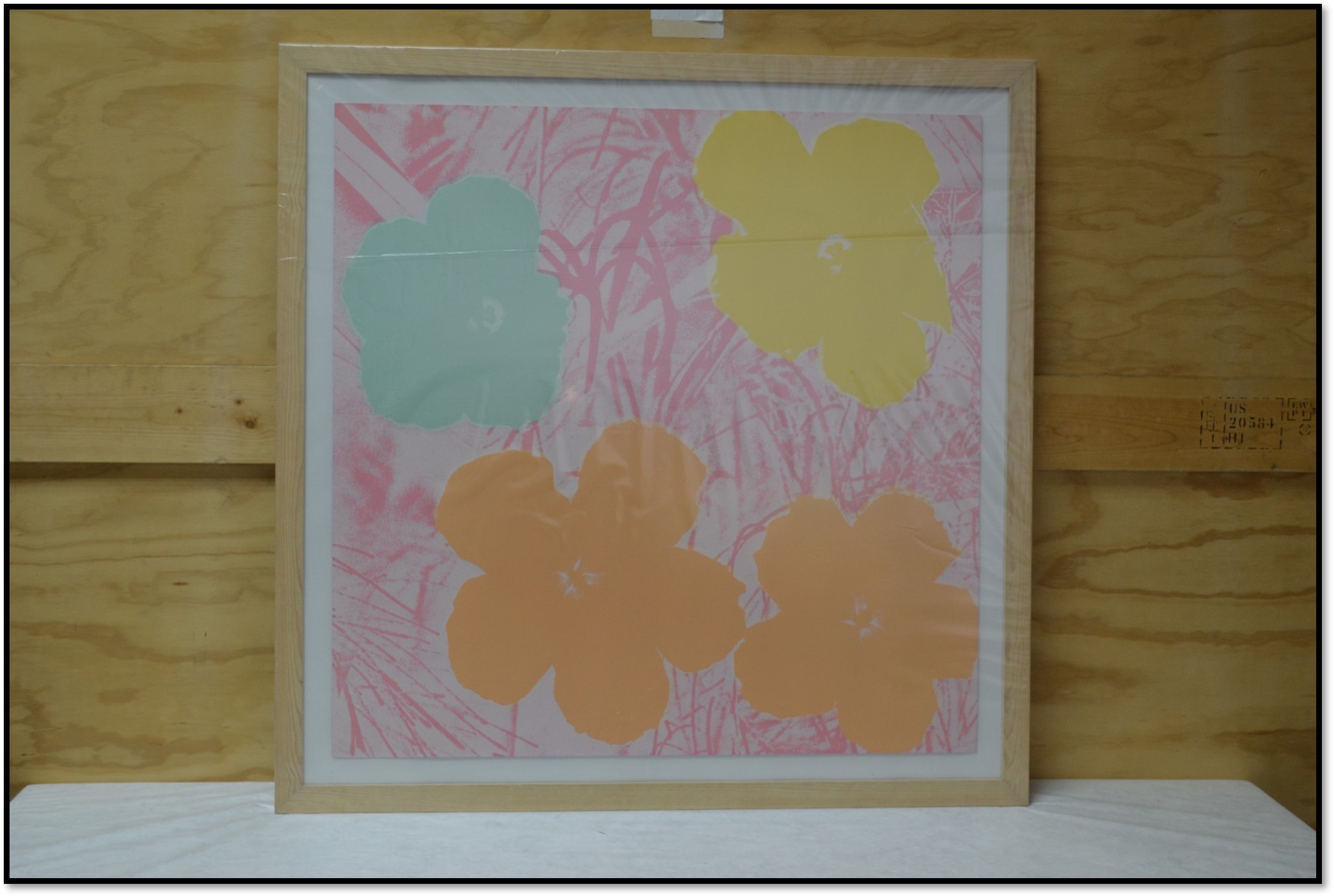 Framed Andy Warhol print of flowers.
