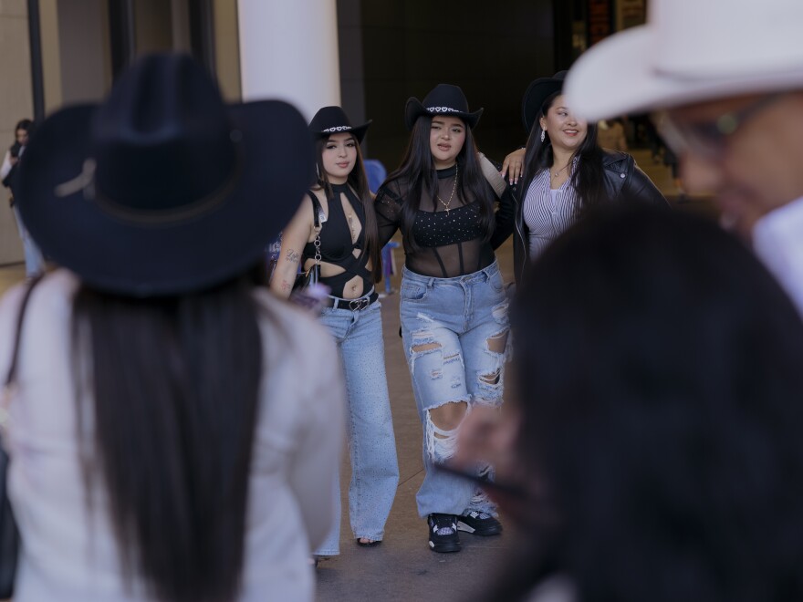 Hundreds of fans of the norteño band Los Tigres del Norte take group photos on the bustling block outside of Madison Square Garden before the start of the Sinaloa, Mexico band's show at Madison Square Garden.