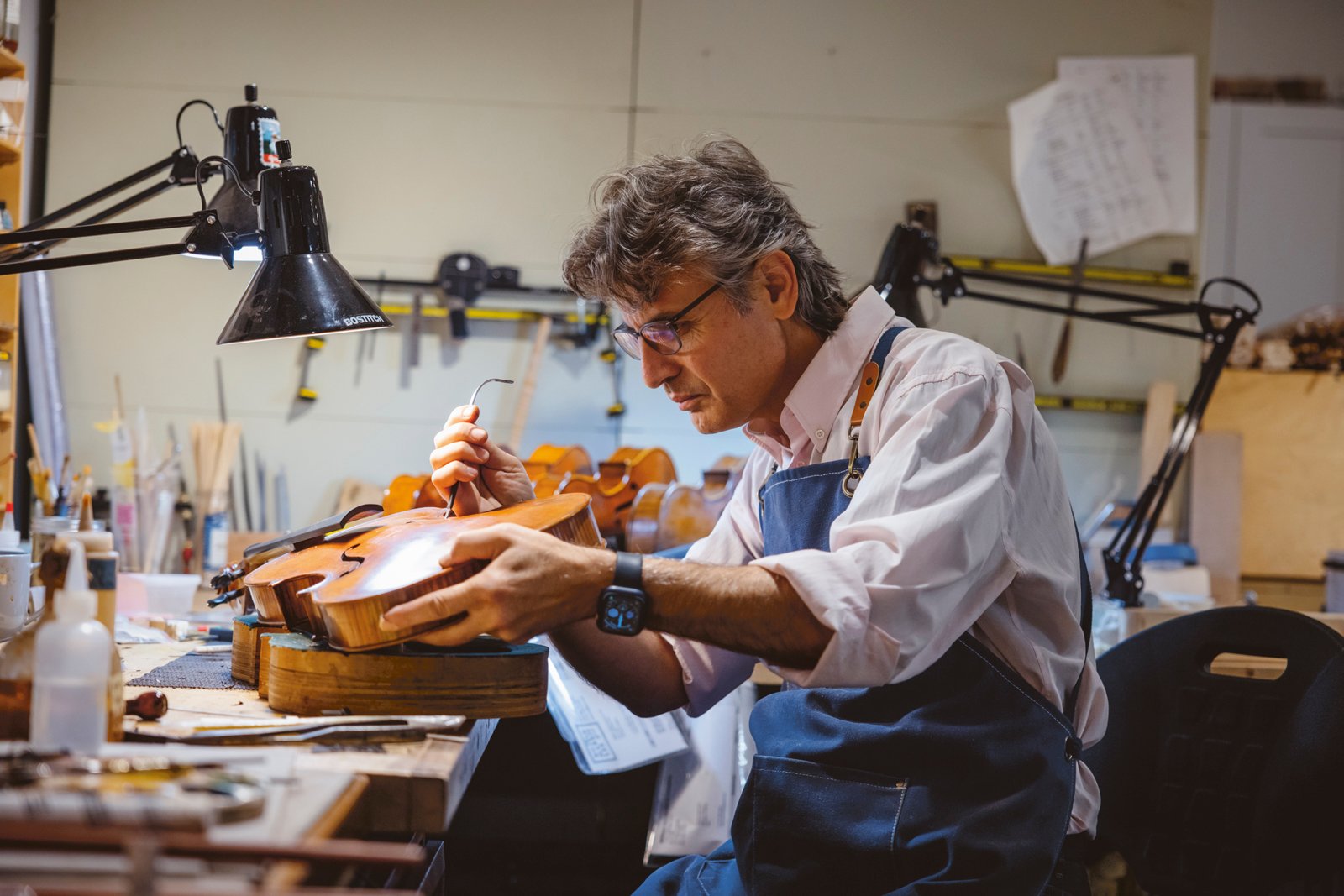 Master instrument makers are among the longstanding tenants of the Fine Arts Building. Credit: Provided A man at a workbench makes a viola