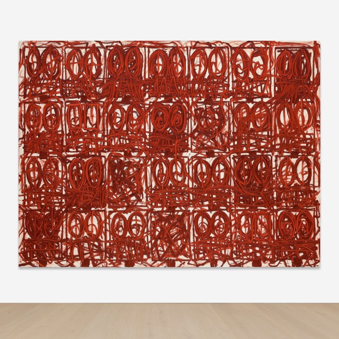 An abstract artwork consists of a canvas divided into squares, each filled with shapes, mostly circles, roughly drawn, and entirely in red; there are also lines and squiggles running across the artwork