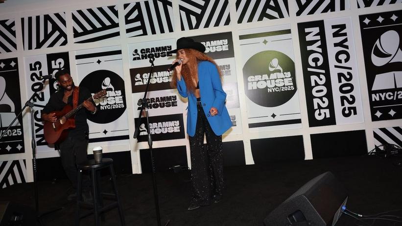 Tiera Kennedy performs at the Celebrating Independent Voices in Music showcase, in Collaboration with A2IM, at GRAMMY House NYC on Friday, June 13, 2025. Tiera wears a blue blazer jacket and a black cowboy hat.