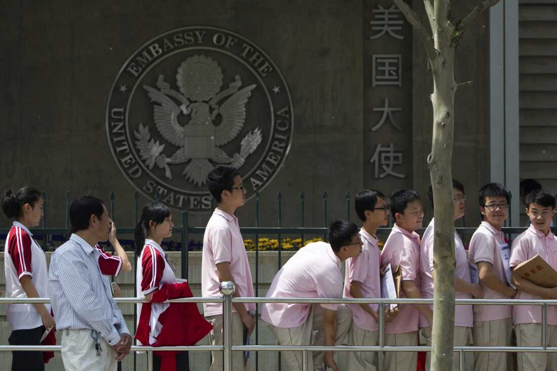 Chinese students wait outside the U.S. Embassy for their visa application interviews, in Beijing on May 2, 2012.